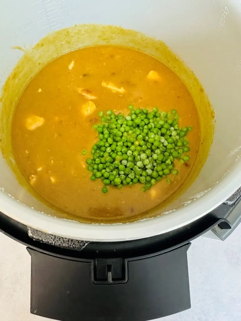 adding peas to Chinese style chicken curry