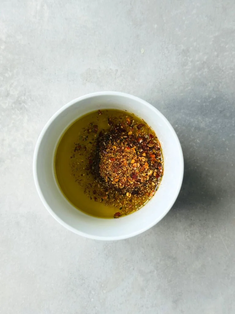 piri piri spice mixed in with olive oil in a white bowl