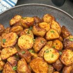 air fryer roasted new potatoes with fresh coriander herbs sprinkled on top