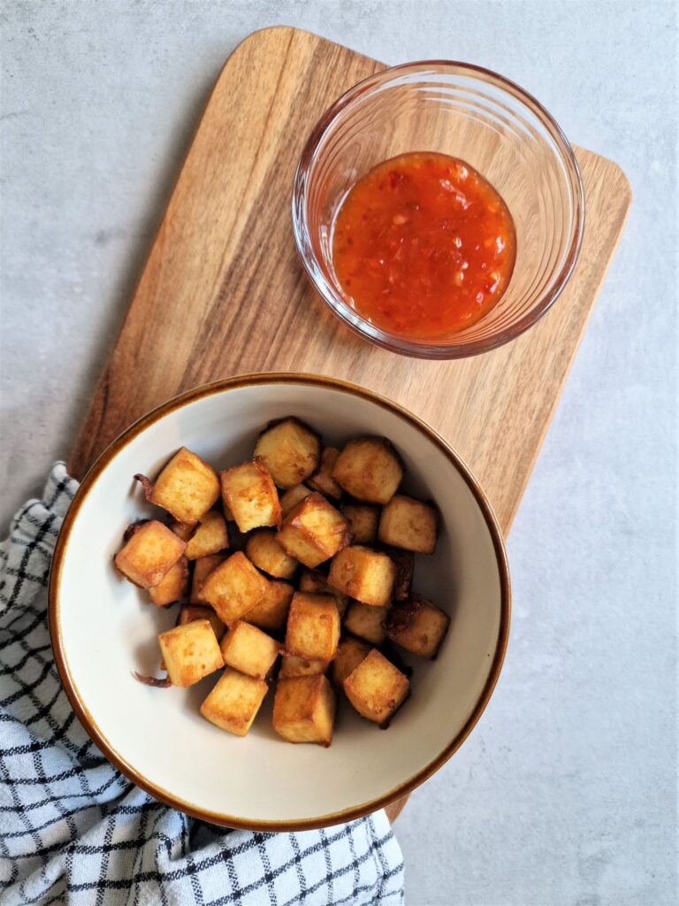 air fried tofu in a bowl with a sweet chilli dip