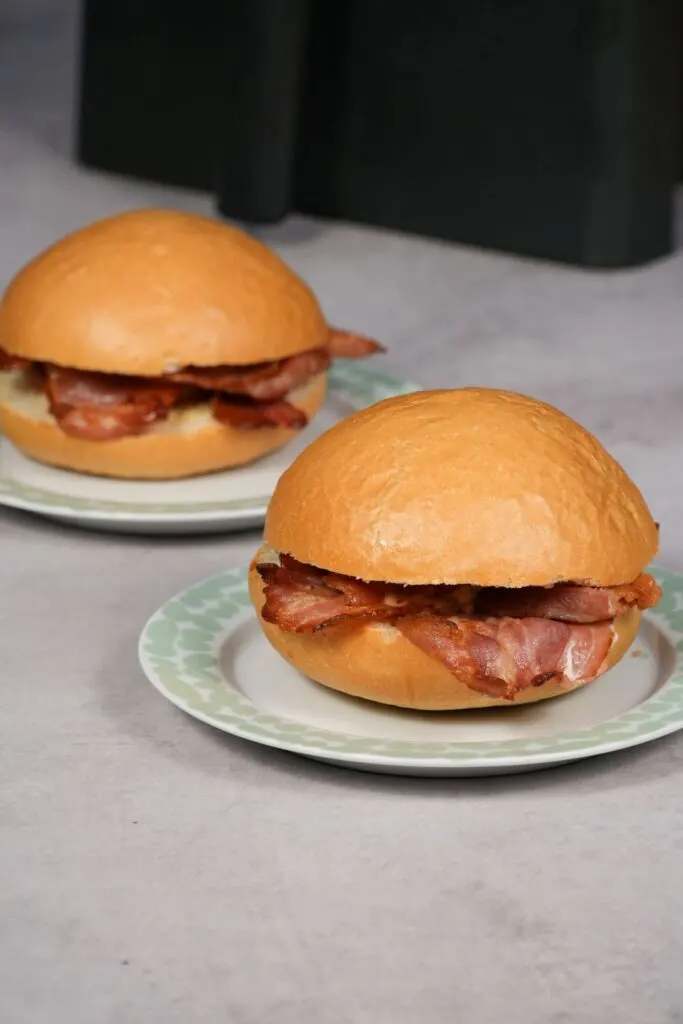 two bacon rolls next to an air fryer