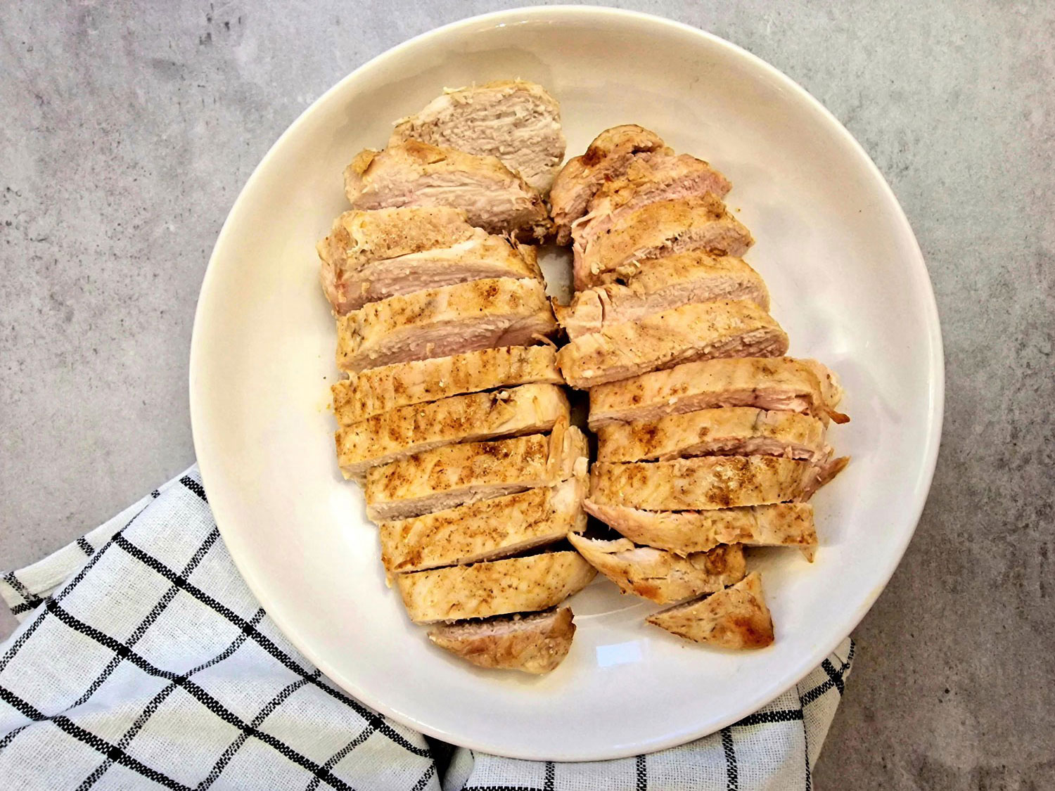 air fryer chicken breasts sliced on a plate