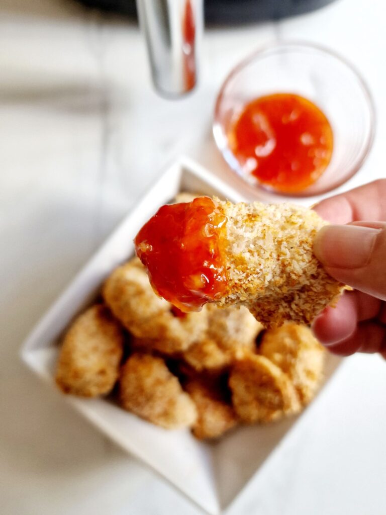 air fryer chicken nugget dipped into sauce