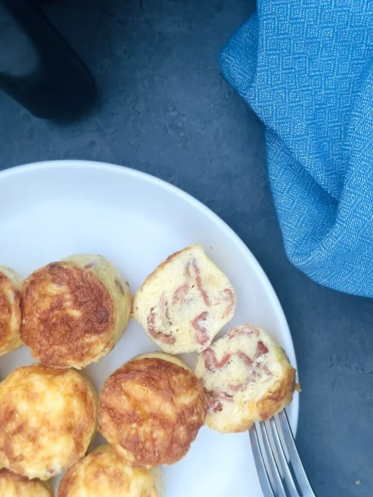 egg bites on a plate next to an air fryer
