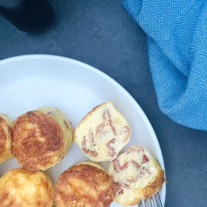 egg bites on a plate next to an air fryer