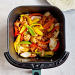 chicken and vegetables in air fryer basket