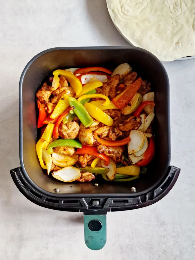 chicken and vegetables in air fryer basket