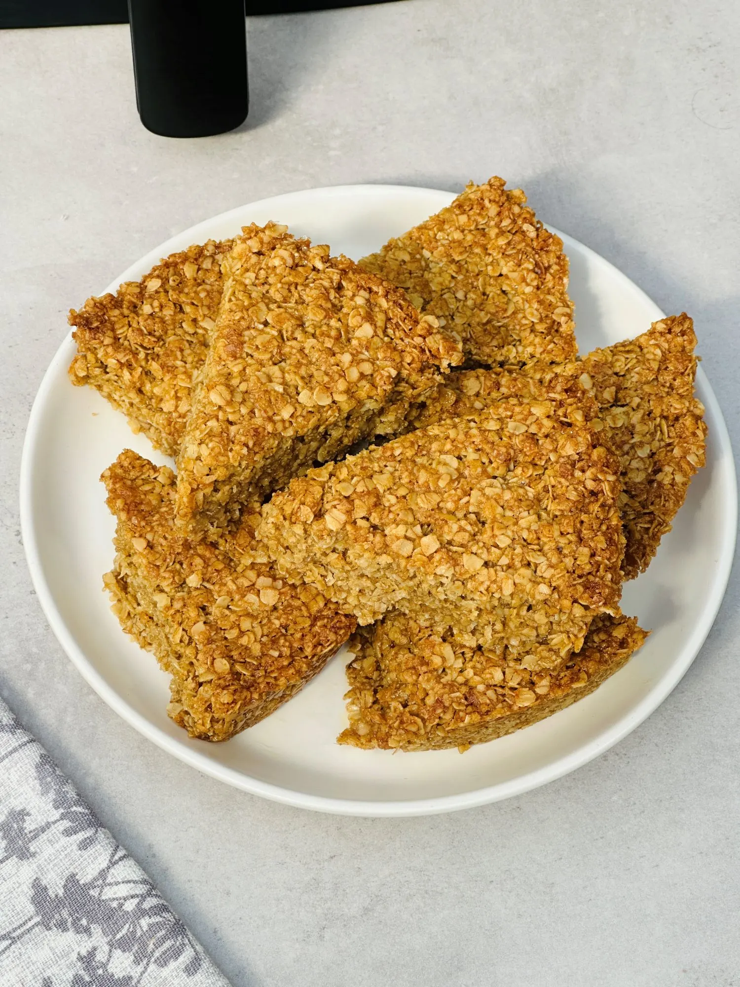 sliced flapjacks on a plate next to an air fryer