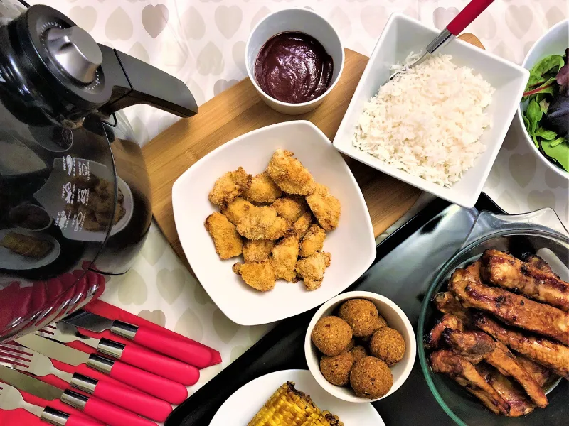 air fryer with air fried food  next to it