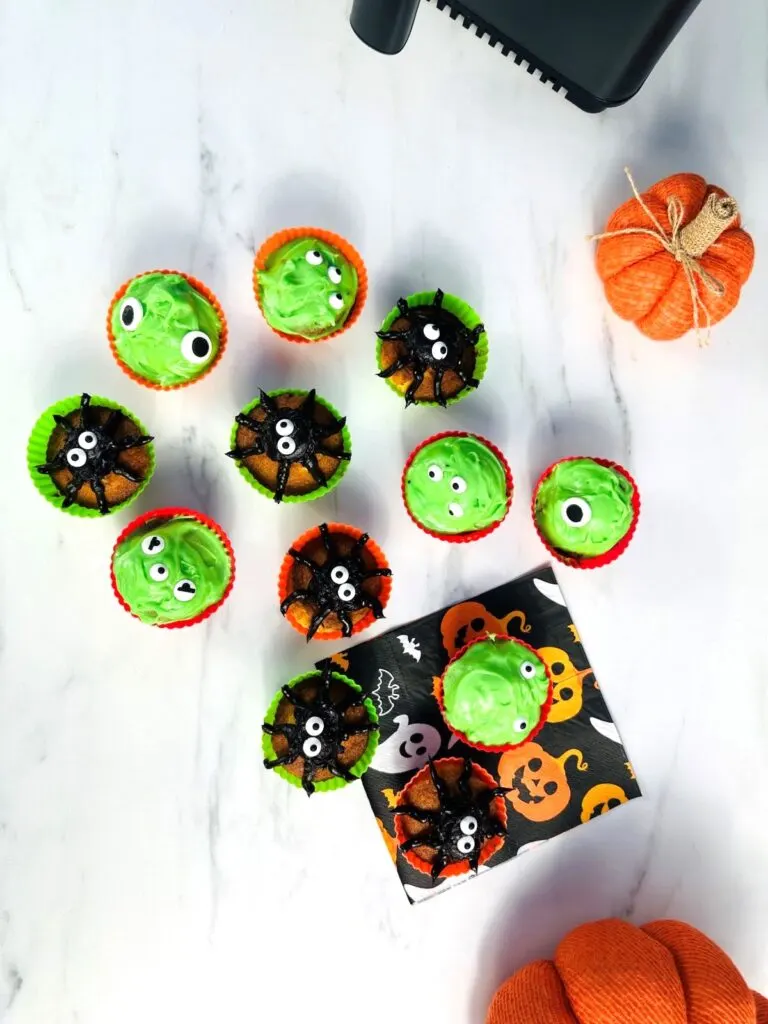 Halloween decorated cupcakes next to air fryer