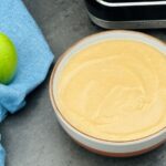 apple and parsnip soup in a bowl next to a Granny Smith apple and a Ninja Soup Maker