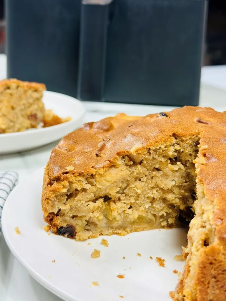 sliced apple cake next to an air fryer