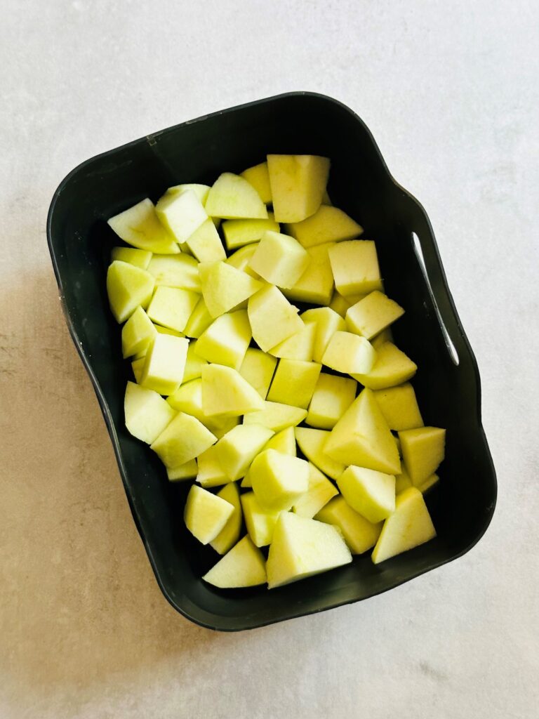 chunks of chopped up Bramley apples in an air fryer silicone liner