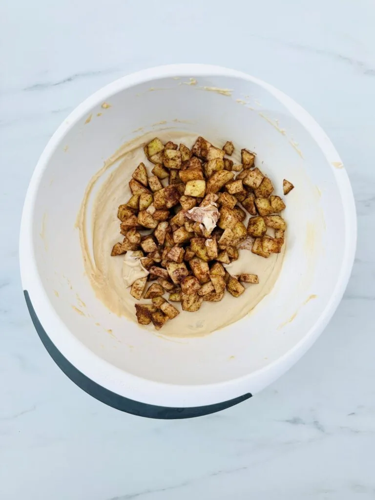 apple mixed into batter for cake