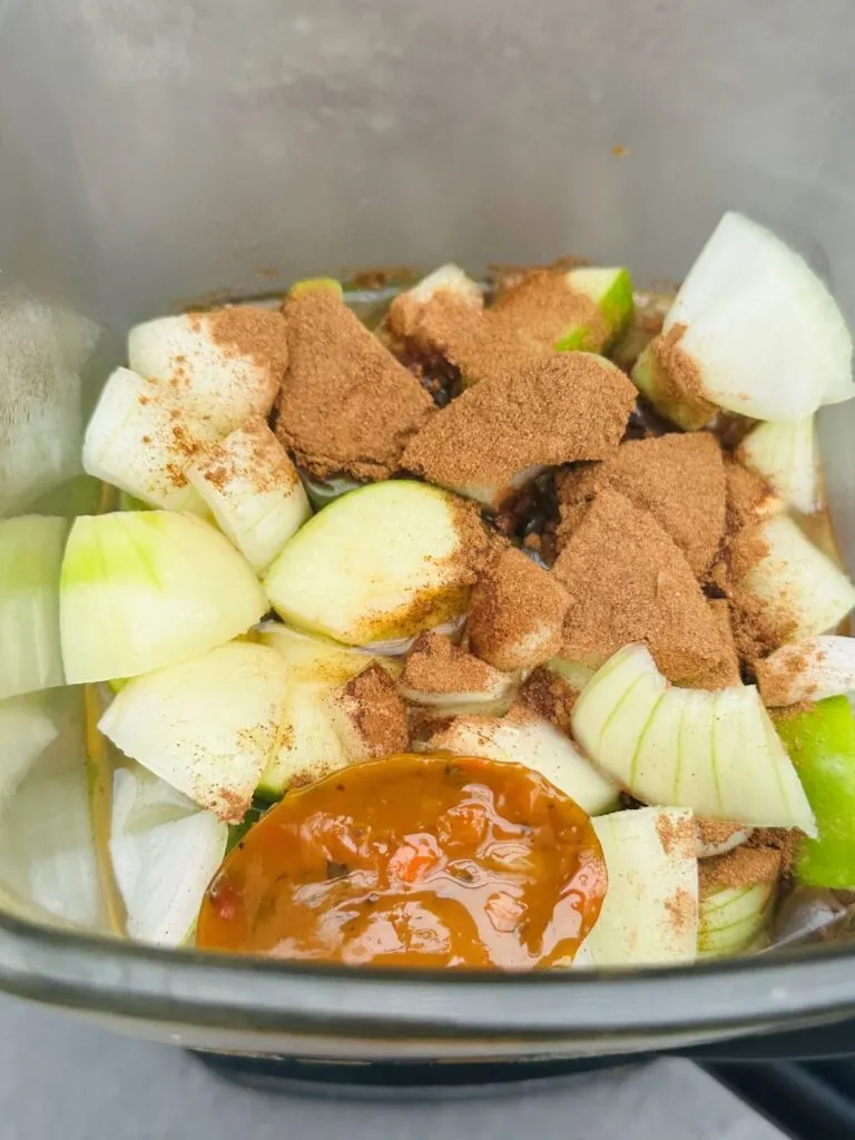 ingredients for apple and parsnip soup added to Ninja soup maker, chopped granny smith apples, parsnips, onion, cinnamon and vegetable stock pot