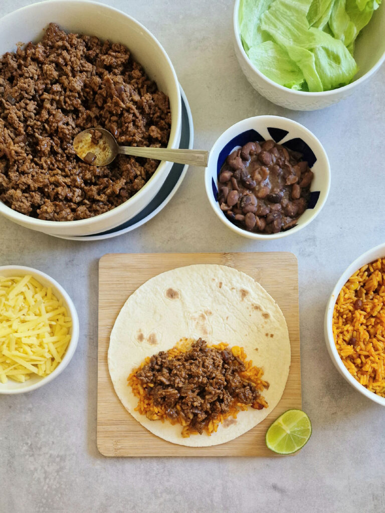 ingredients laid out for assembling a beef burrito