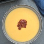 bacon and lentil soup in a bowl next to a ninja soup maker