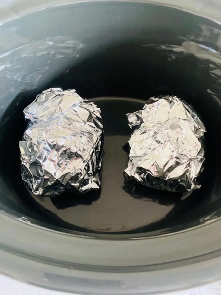 baked potatoes in slow cooker wrapped in foil