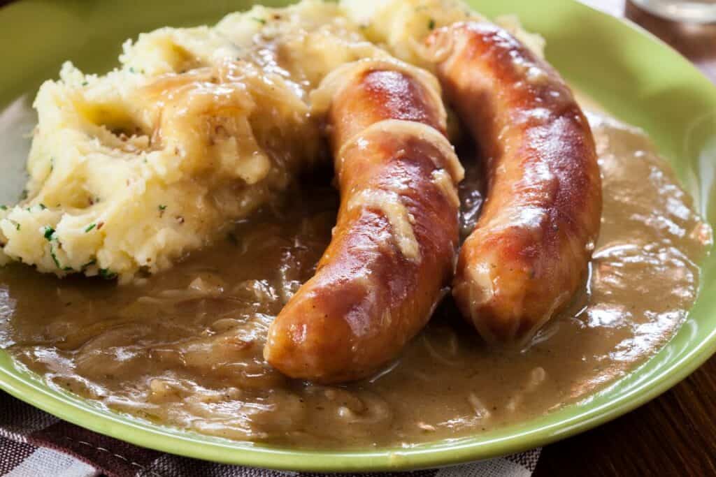 sausages and mashed potato covered in onion gravy