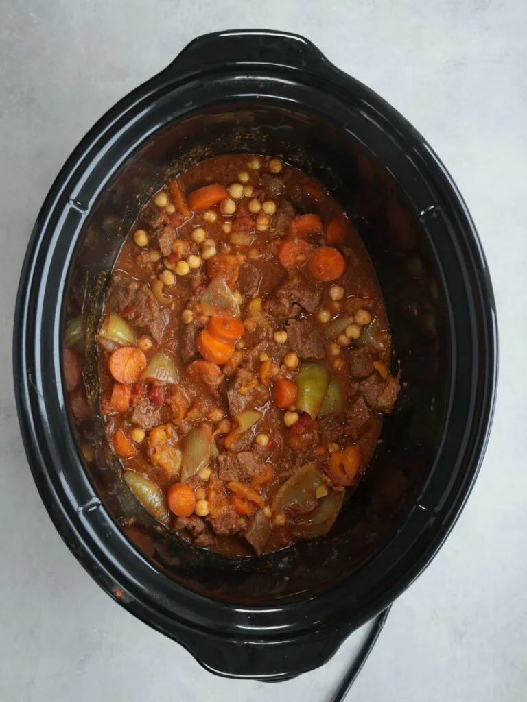 cooked Moroccan style beef chickpea stew in a slow cooker with carrots