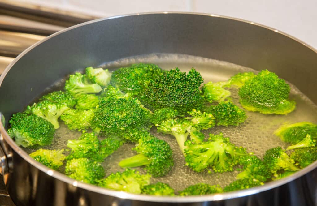 raw broccoli in boiling water for blanching