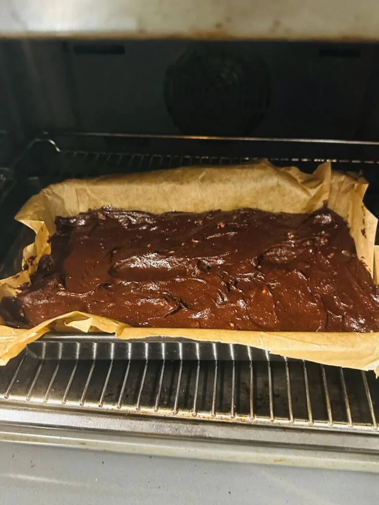 brownie batter in baking tin in oven