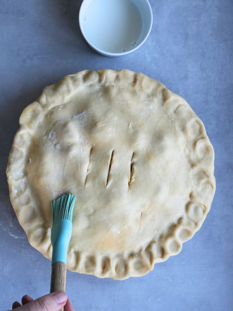 brushing pastry lid with some milk