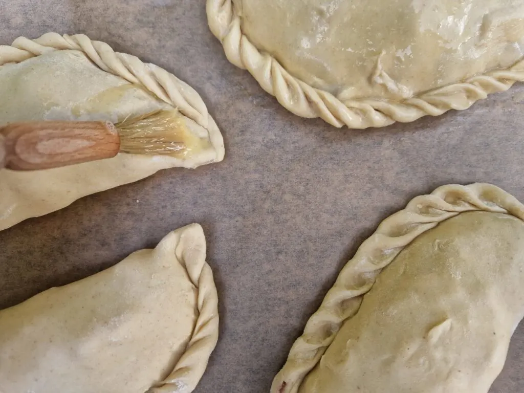 brushing pasties with beaten egg