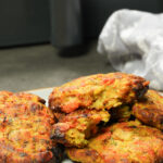 bubble and squeak patties next to air fryer basket