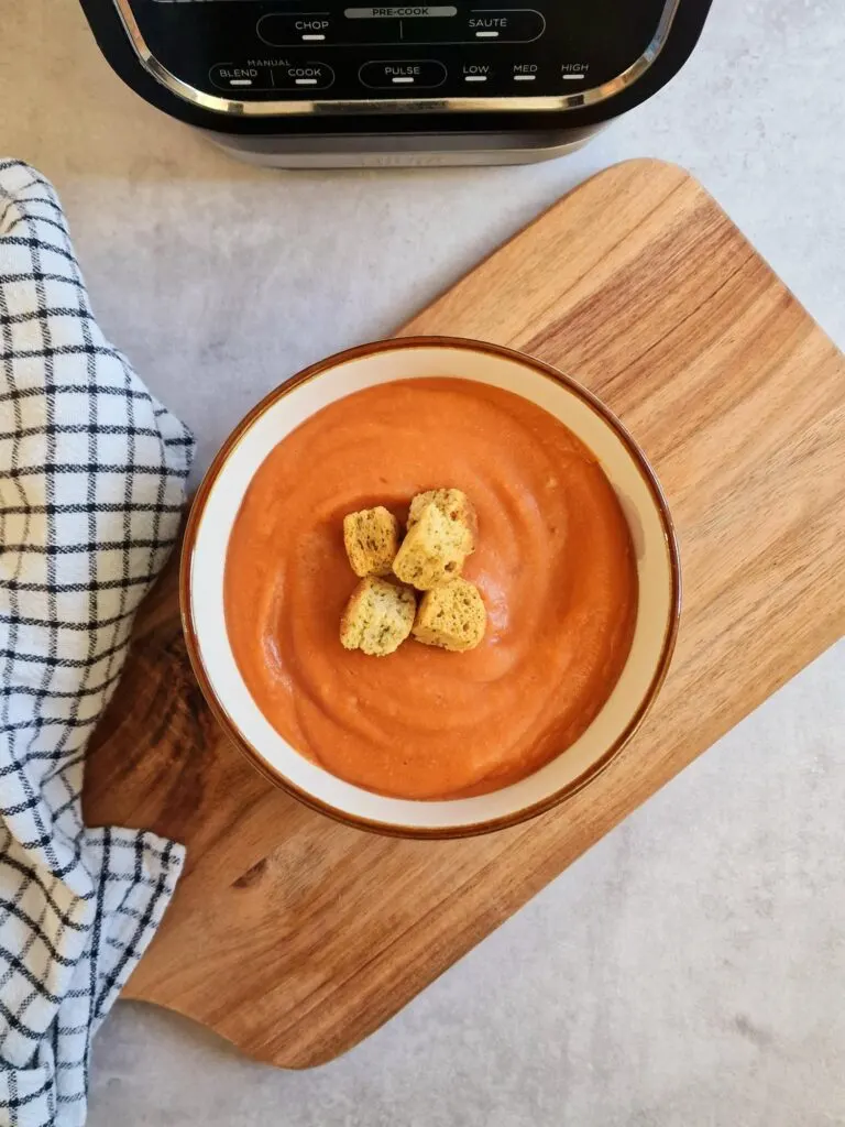butter bean and lentil soup in a bowl next to the ninja soup maker