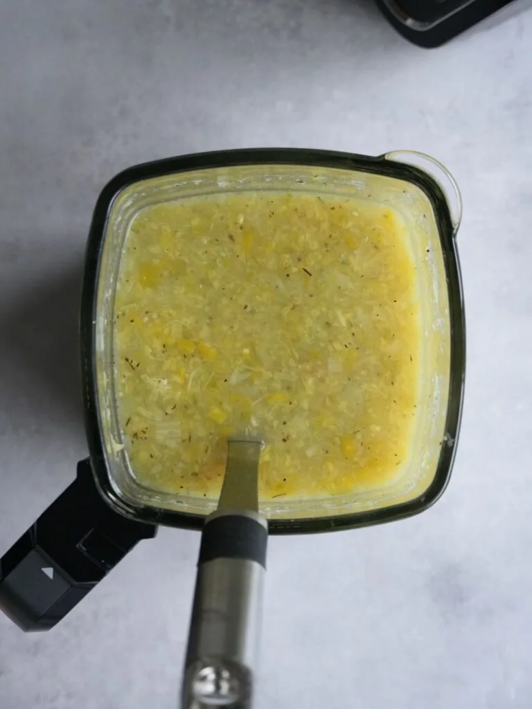 cooked cabbage and leek soup in a ninja soup maker jug with a serving spoon in it