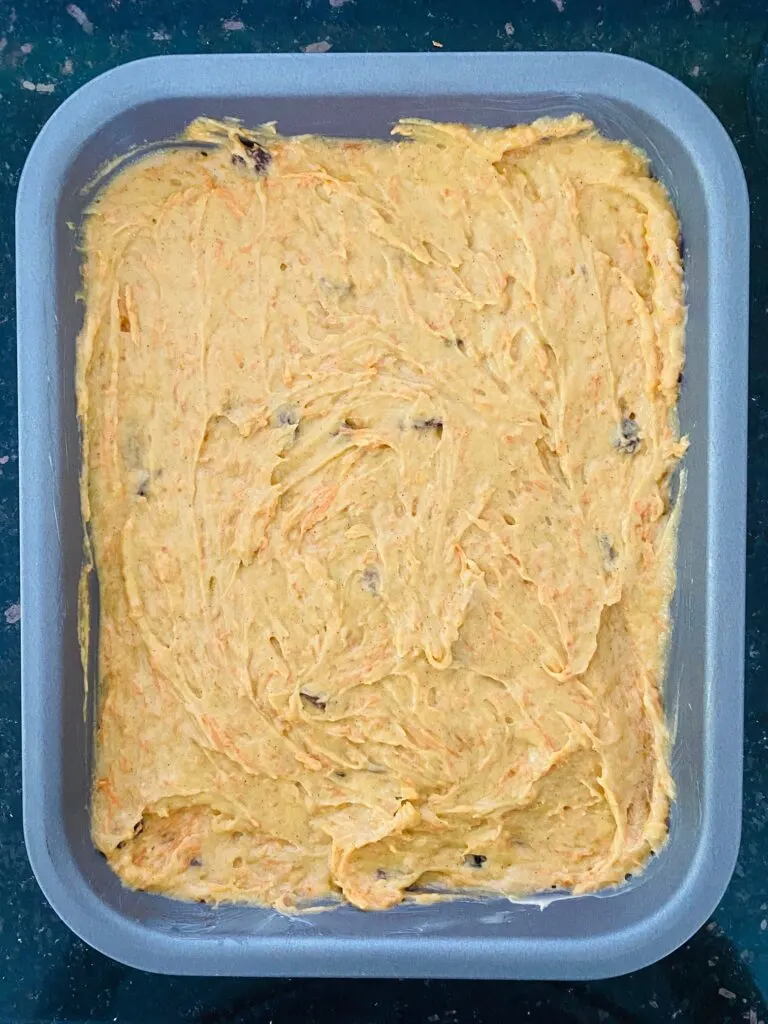 carrot cake batter in baking tray ready to cook for a carrot cake tray bake