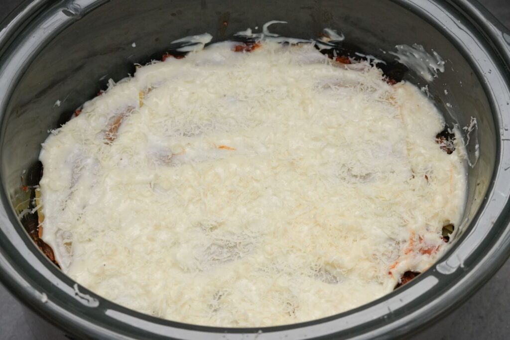 cheese sprinkled on lasagne in slow cooker