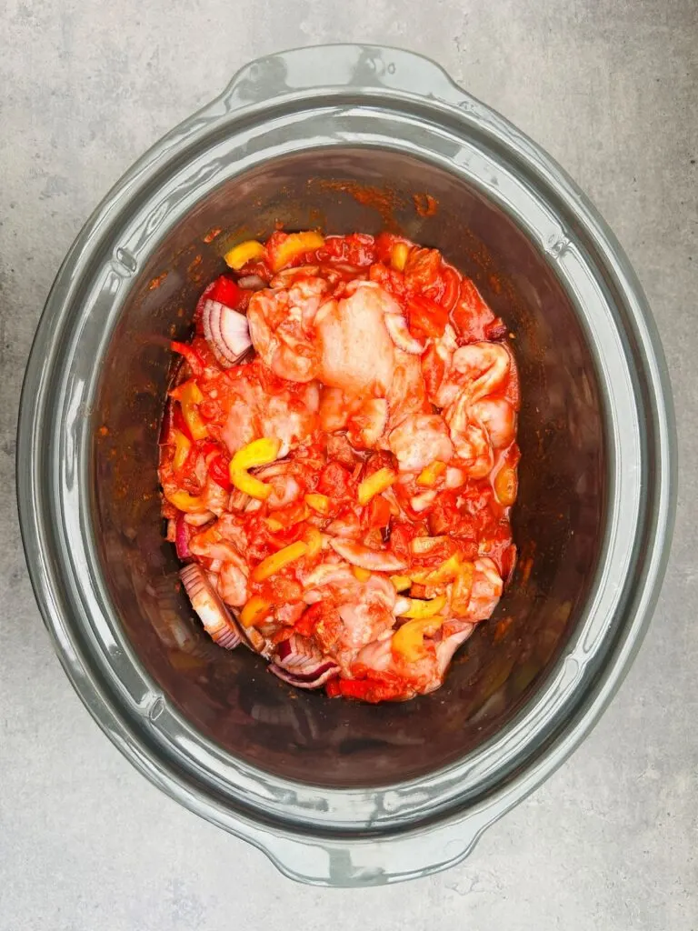 chicken and chorizo stirred together in slow cooker