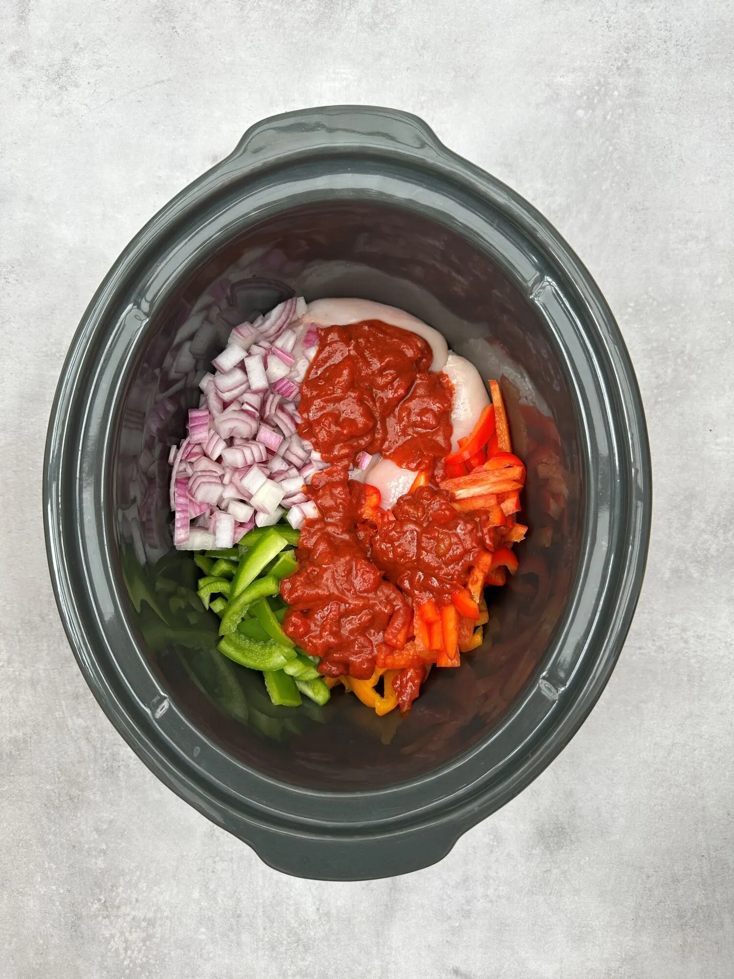 all ingredients in slow cooker for chicken fajitas