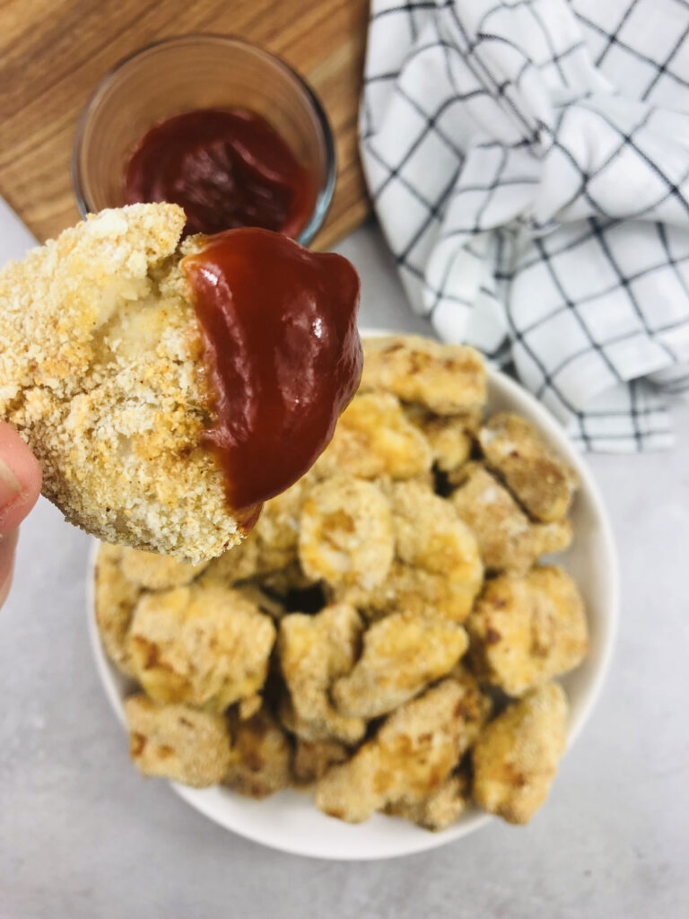 chicken nuggets dipped in tomato ketchup