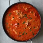 chicken paprika in a ninja pan with fresh parsley sprinkled on top
