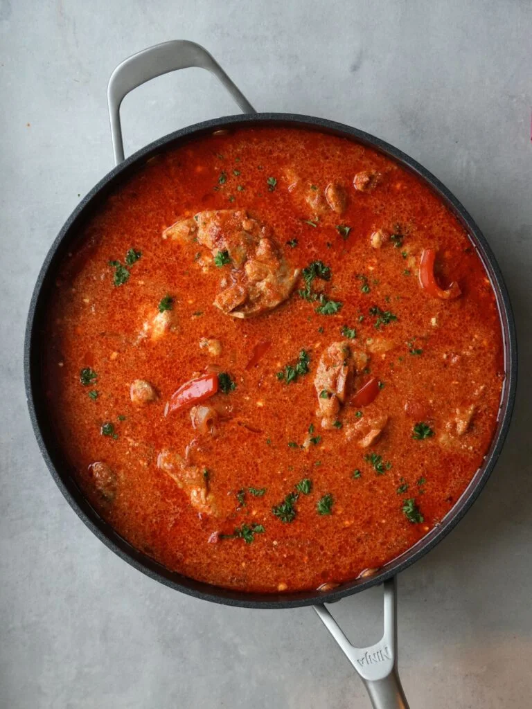 chicken paprika in a ninja pan with fresh parsley sprinkled on top