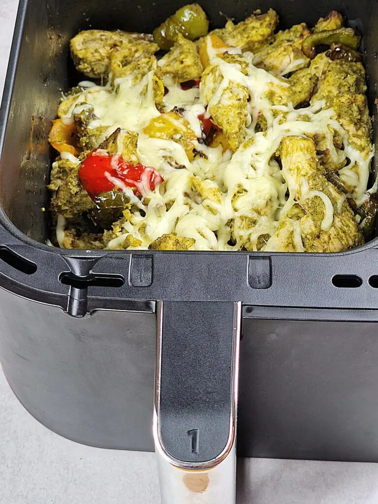melted cheese on chicken pesto in an air fryer.