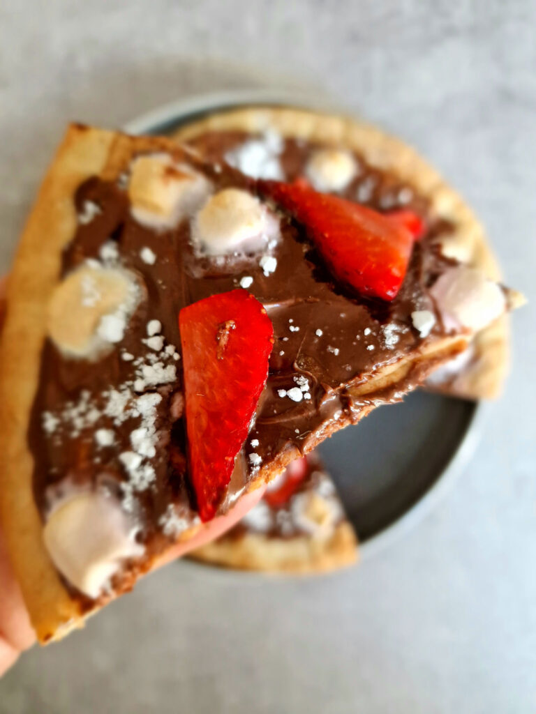 Nutella Chocolate Pizza Slice with strawberries and marshmallows on top