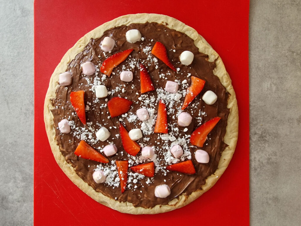 Nutella Chocolate Pizza sprinkled with icing sugar