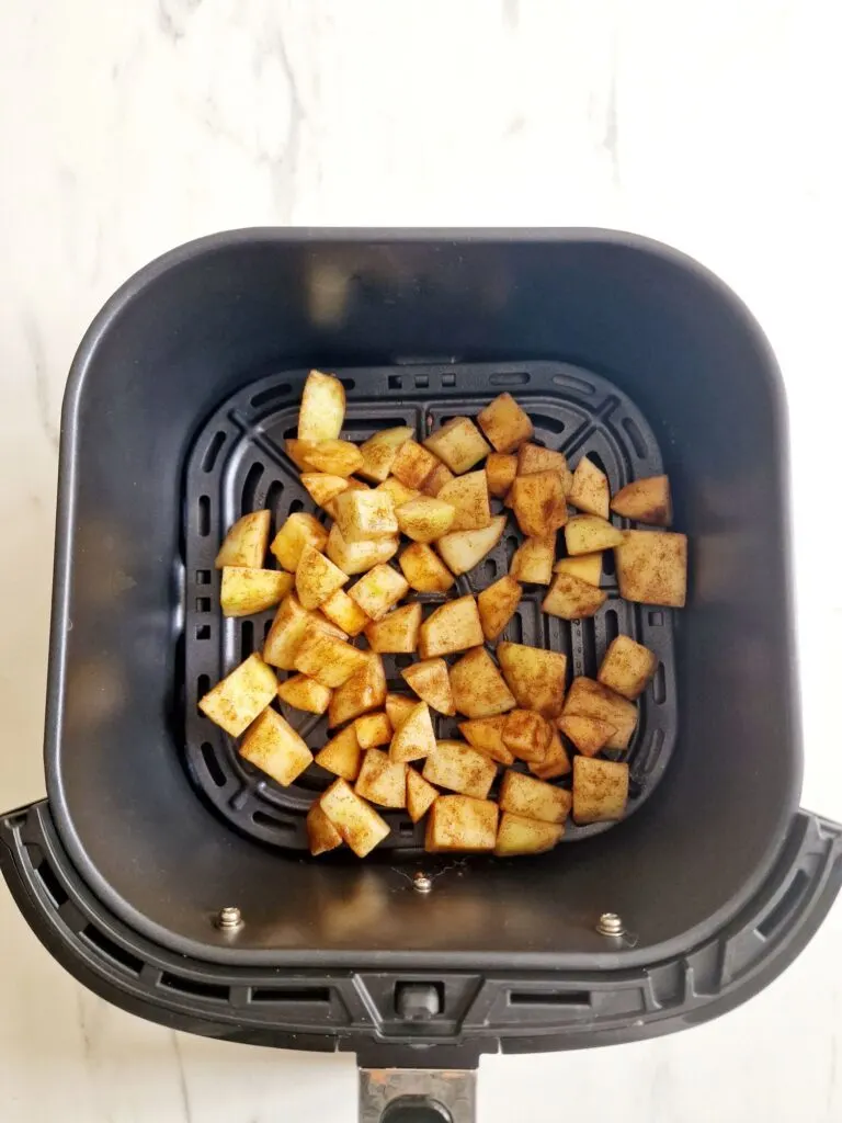 chopped apple in air fryer basket