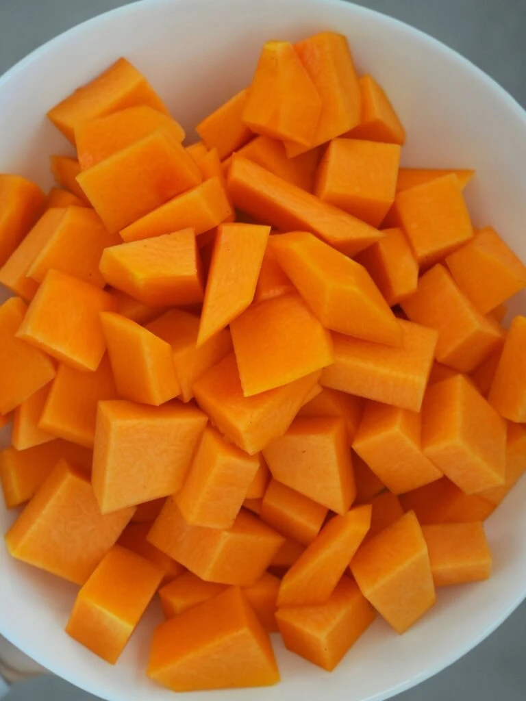 peeled and chopped butternut squash in a white bowl