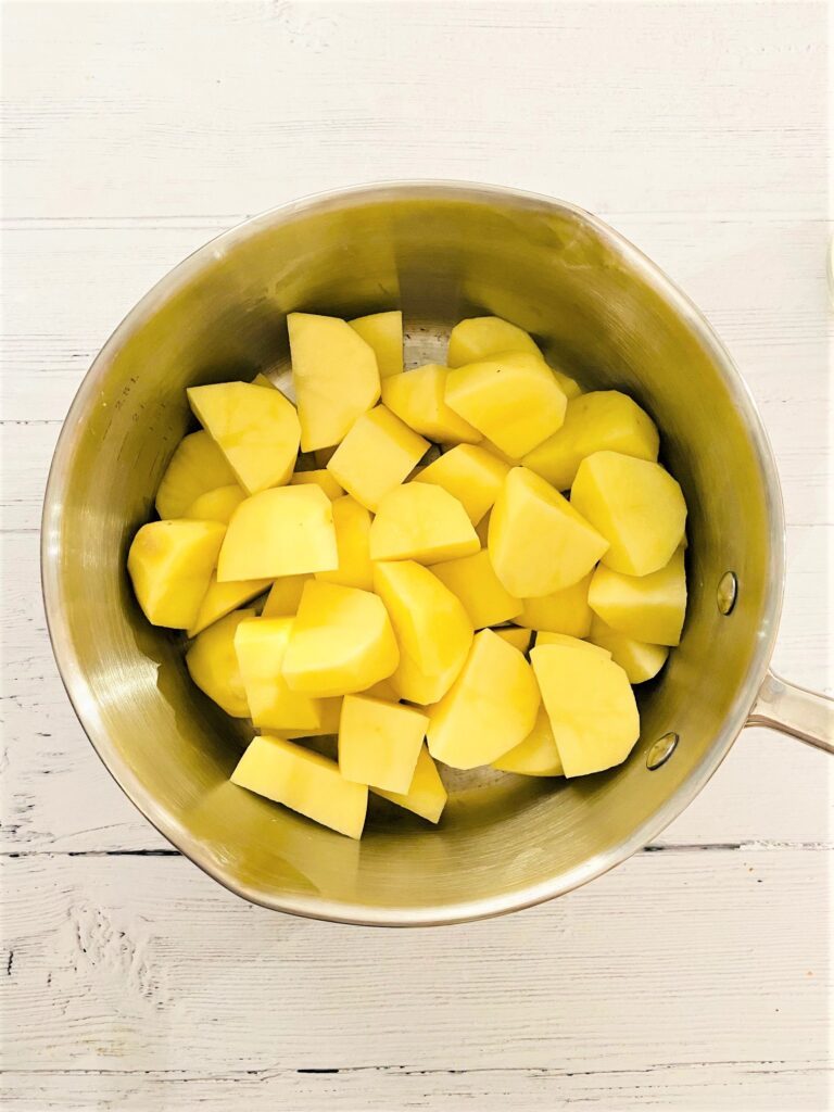 chopped potatoes in saucepan ready for mashed potato