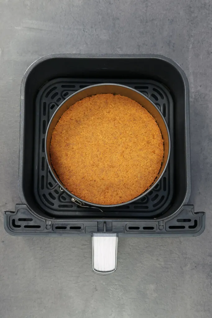baking tin with cooked biscuit base in air fryer basket
