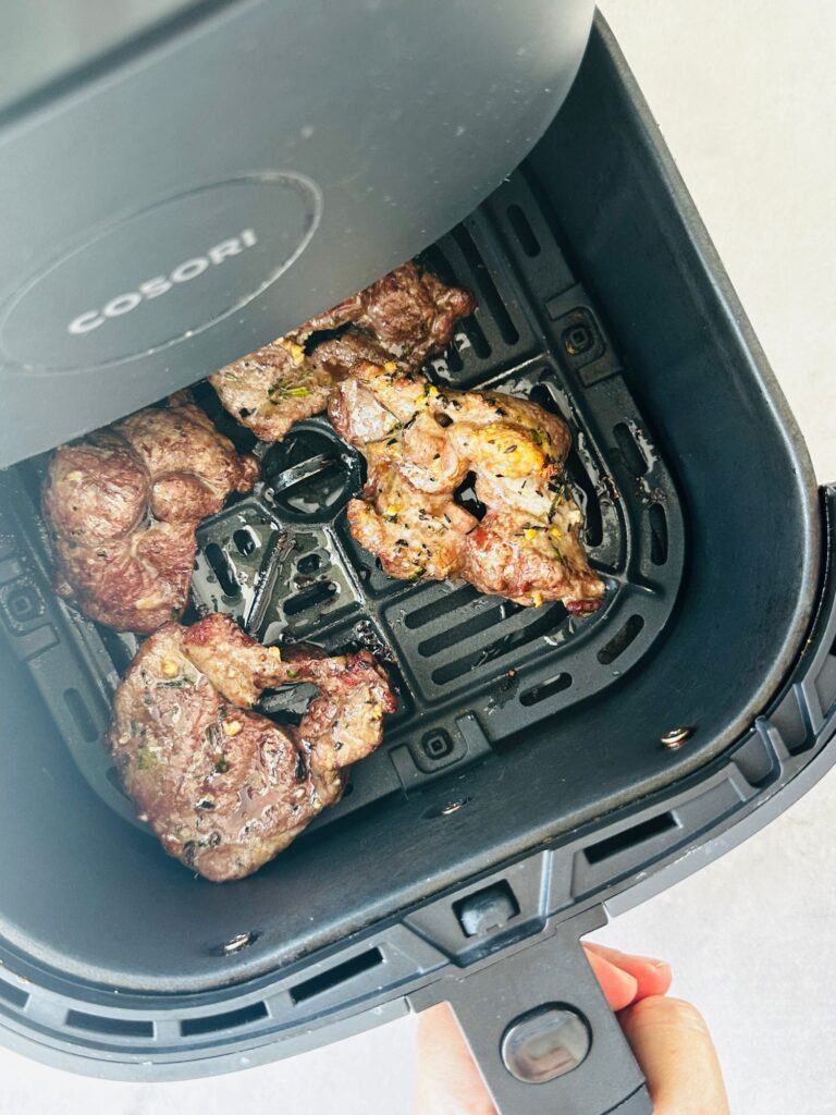 cooked lamb steaks in air fryer basket