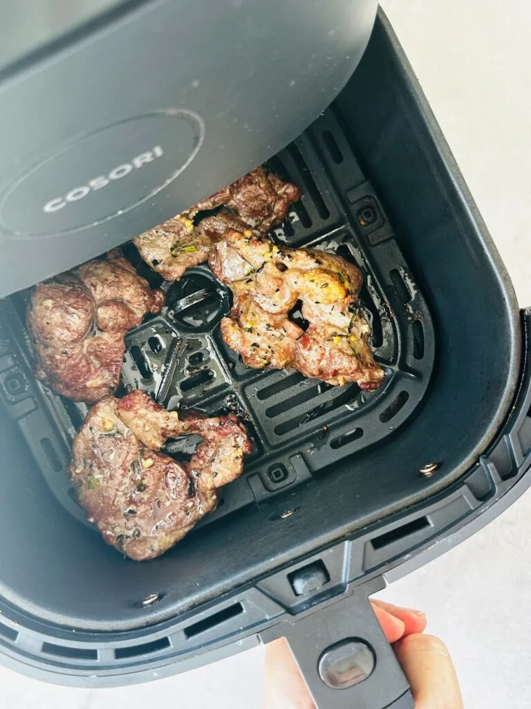 cooked lamb steaks in air fryer basket