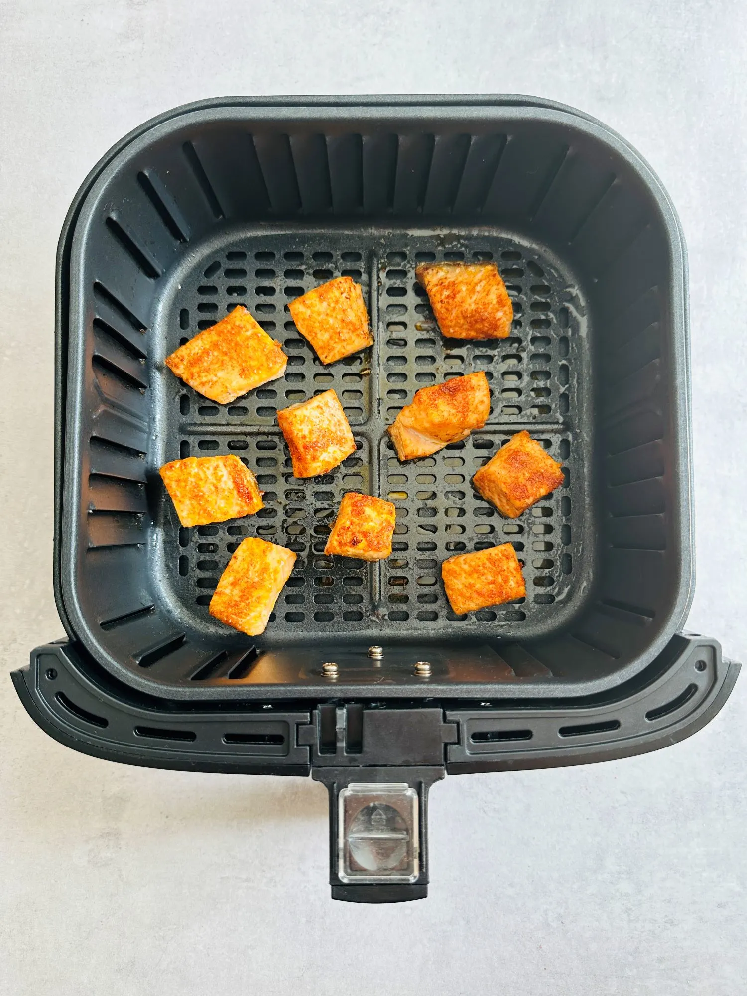 cooked salmon bites in an air fryer