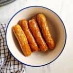 air fryer frozen sausages cooked in a bowl