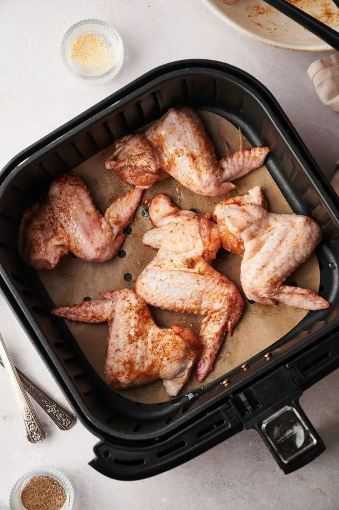 chicken wings in an air fryer basket